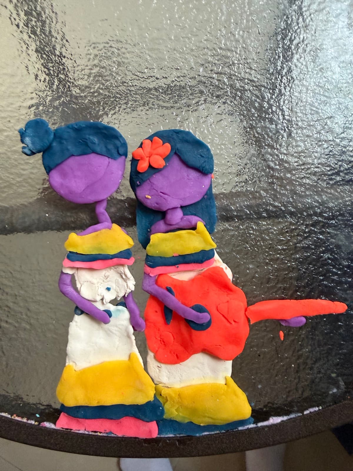 Clay artwork of two figures playing guitar